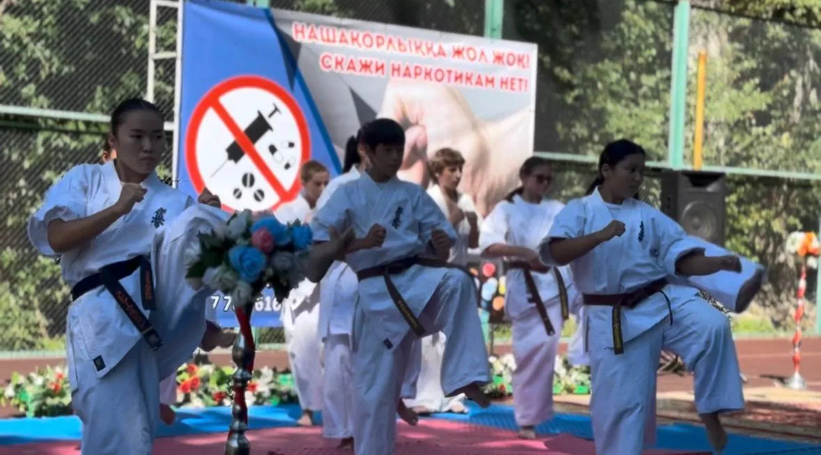 Дети в лагере Жетісу получают брошюры и участвуют в спортивных состязаниях по профилактике наркомании.