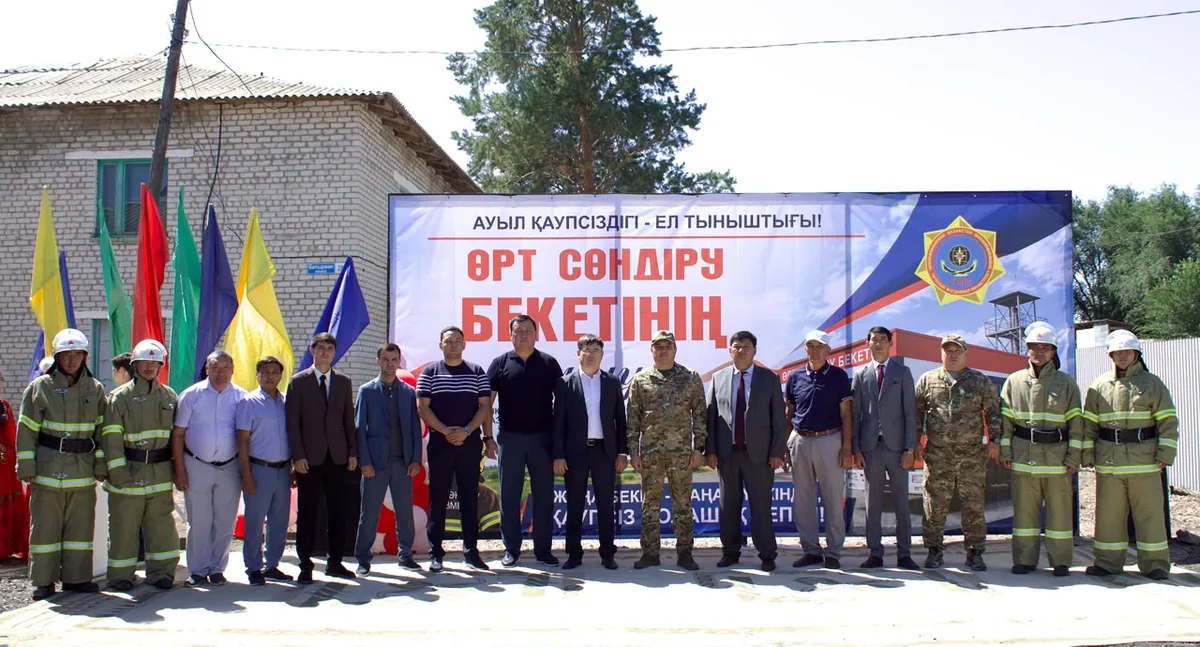 Церемония открытия добровольного противопожарного формирования «Ауыл құтқарушылары» в селе Алгабас, рядом с новой пожарной машиной и сотрудниками.