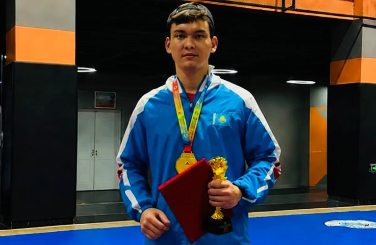Спортсмен Асылжан Захариев из Жетісу с чемпионским поясом по ММА после победы.